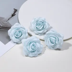 Vista dettagliata di teste di rose artificiali azzurre con gocce di rugiada
