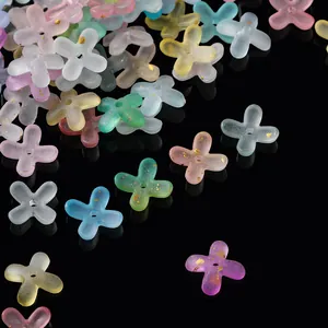 Close-up macro view of frosted acrylic four-petal flower spacers with gold flecks