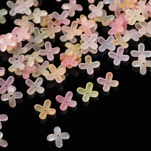 Close-up of frosted acrylic four-petal flower spacer beads with elegant gold foil flakes