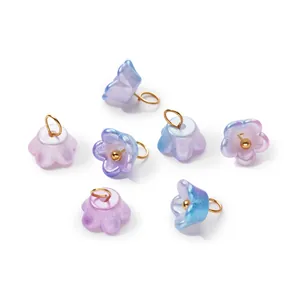 Close-up detail of iridescent pearlescent ABS flower charms with golden hanging rings