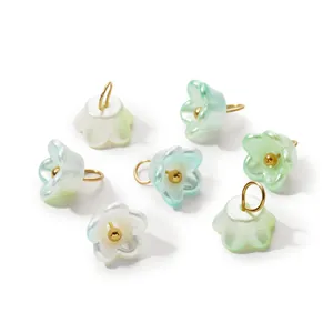 Detailed view of iridescent bell flower charms with gold loops for DIY handmade jewelry.