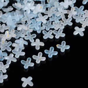 Detail view of blue gradient acrylic flower beads with gold foil for DIY jewelry making.
