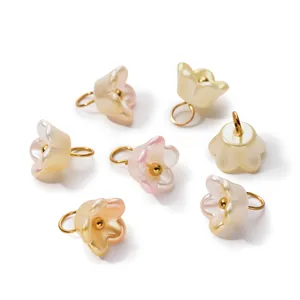 Detailed view of pearlescent ABS flower charms with gold rings for DIY jewelry making