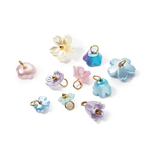 Close-up of colorful ABS imitation pearl flower charms with gold rings for DIY jewelry making
