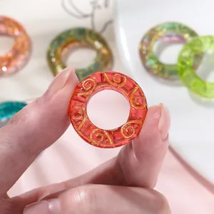 Macro detail of a red ice-translucent glaze ring with elegant gold swirl patterns for DIY