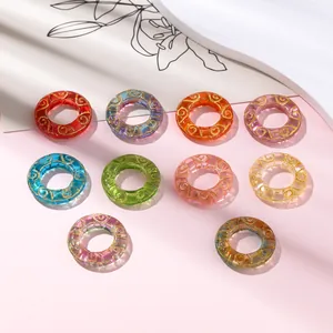 Colorful translucent glass donut rings with golden swirl patterns for jewelry DIY