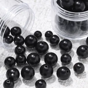 Close-up detail of natural black sandalwood round beads for DIY jewelry crafting