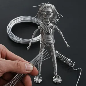 Detailed view of flexible silver coated aluminum wire used to craft a handmade wire figurine.