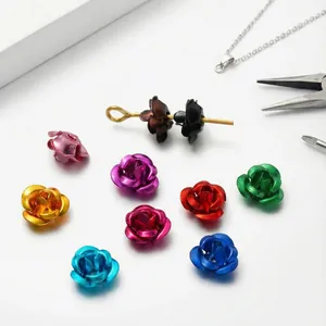 Macro detail view of various colorful 3D aluminum rose flower beads for DIY jewelry making