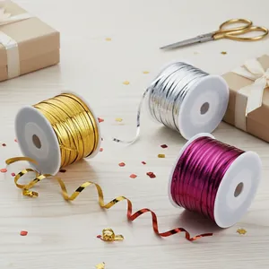 Close-up of metallic PET twist ties in gold, silver and magenta for gift packaging.