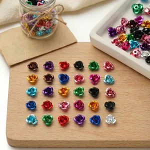 Colorful 3D aluminum rose flower beads neatly arranged on a wooden board for DIY jewelry