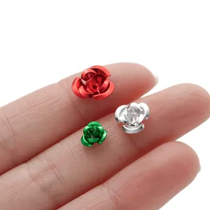 Close-up of colorful aluminum rose flower charms for DIY jewelry making on fingers