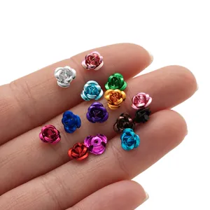 Colorful mini aluminum rose flower charms for DIY jewelry making displayed on a hand