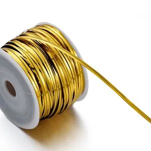 Close-up detail of golden PET metallic twist ties wound neatly on a white plastic spool