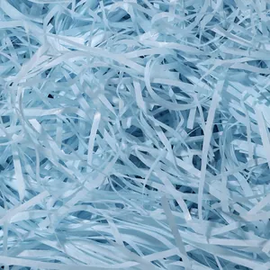 Dettaglio macro di carta triturata azzurra utilizzata come riempitivo per scatole regalo