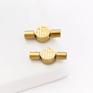 Macro view of golden stainless steel Fu character clasps for DIY jewelry making craft