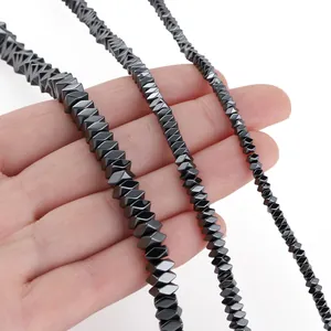 Close-up detail of black hematite rhombus beads in three sizes for DIY jewelry making.