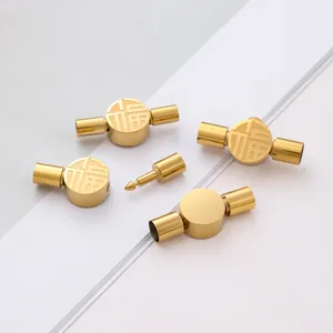 Detailed view of gold stainless steel clasp with engraved Fu character for DIY jewelry.