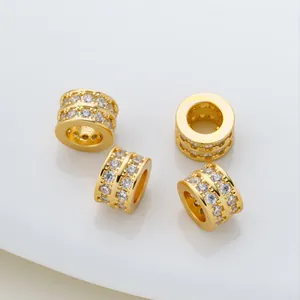 Close-up of gold-plated barrel beads with double-row micro-pave cubic zirconia.