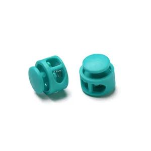Close-up of turquoise dual-hole plastic spring cord locks for drawstring adjustment