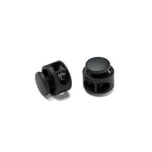 Detail view of two black round double-hole plastic spring cord locks for drawstring adjustment.