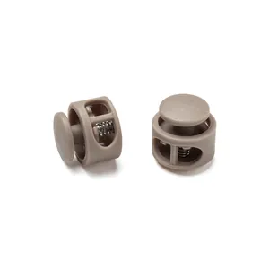 Detailed view of durable khaki round plastic spring cord locks with internal metal springs