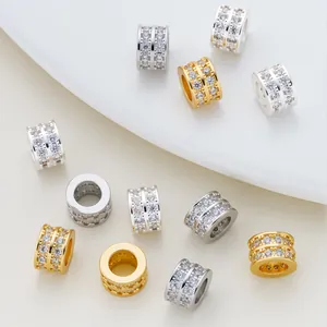 Macro view of double-row micro-paved cubic zirconia barrel charms in gold and silver