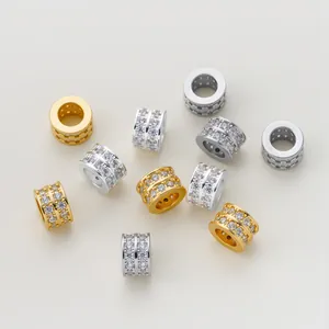 Group of gold and silver plated barrel beads with double row zirconia for DIY bracelets.