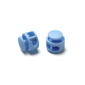 Close-up detail of light blue round double-hole plastic spring cord toggle locks