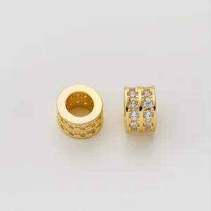Detailed view of gold-plated copper barrel charm with double row micro-paved cubic zirconia