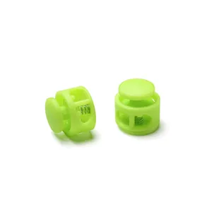 Close-up of lime green round double-hole plastic spring cord locks for elastic ropes