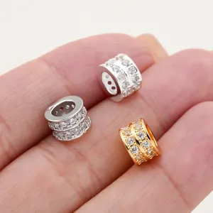 Close-up detail of micro-pave cubic zirconia barrel beads in gold and silver finish