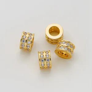 Close-up of gold-plated barrel beads with double-row micro-set zircons for jewelry
