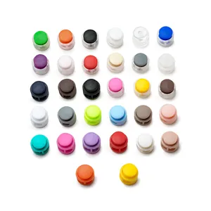 Close-up of colorful circular plastic spring cord locks with dual-hole design