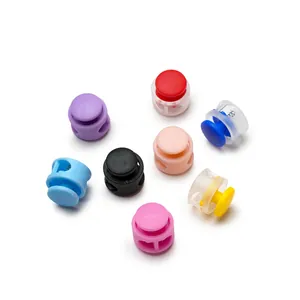 Close-up macro view of various colored plastic spring cord locks and pig nose buckles