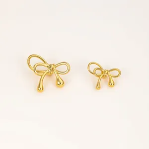 Detailed macro view of gold-plated copper bow-knot spacer beads with waterdrop design