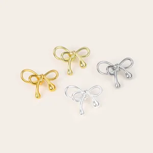 Detailed macro view showing polished bowknot metal spacer beads in gold and silver finishes