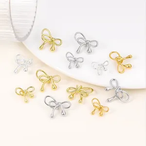 Detailed view of elegant gold and silver plated bow-knot beads for DIY jewelry making accessories
