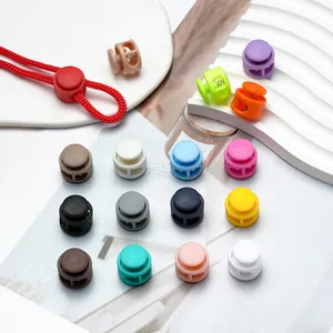 Detailed view of assorted colorful plastic spring cord locks arranged on white background