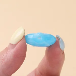Detailed macro view showing the threading hole of a light blue star acrylic bead for DIY