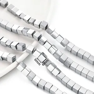 Detailed macro view of 6mm metallic vacuum-plated hematite cube beads for jewelry.