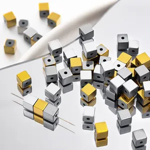 Close-up of cubic hematite beads in silver and gold vacuum plated finish for DIY jewelry