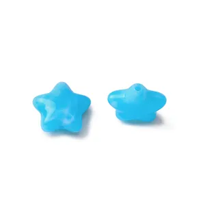 Close-up of bright blue acrylic star-shaped beads with straight holes for DIY jewelry making.