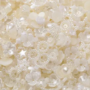 Assorted white acrylic pearl beads in flower and star shapes for DIY jewelry crafting.
