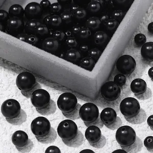 Detailed macro view showing 6-10mm polished black sandalwood beads for DIY jewelry making