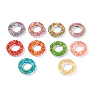 Detail view of colorful translucent glass doughnut beads with golden spiral patterns