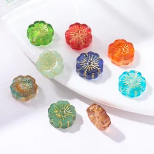 Detail view of vintage flower glass beads with gold-painted centers in various colors.