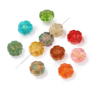 Close-up of assorted vintage gold-painted flower glass beads for DIY jewelry