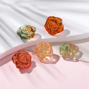Close-up of colorful transparent glass rose beads featuring delicate hand-painted gold edges