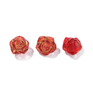 Macro detail of translucent red glass rose beads with gold tracing for DIY crafts